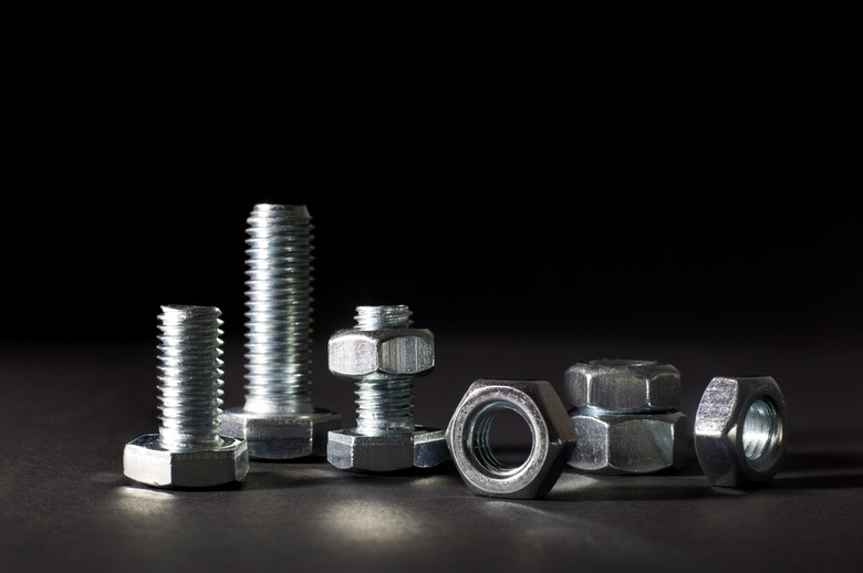 Metal Bolts And Nuts Isolated On Black Background