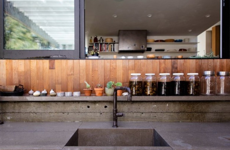 Kitchen with concrete counters and wood backsplash