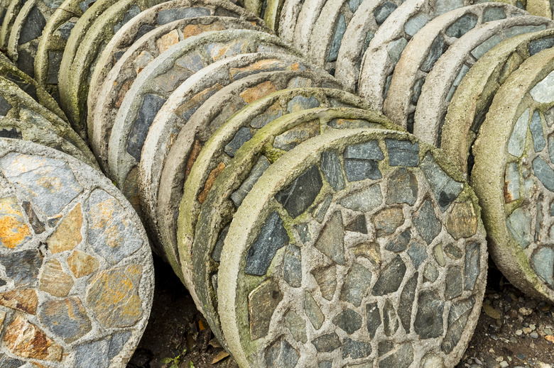 Circular concrete and stone garden stepping stones.