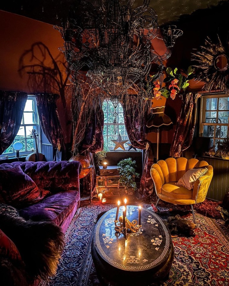 sitting room with dark colors and hanging sculpture made of branches