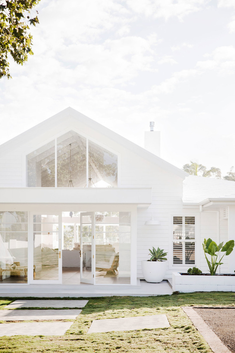 all white home exterior  with oversize windows