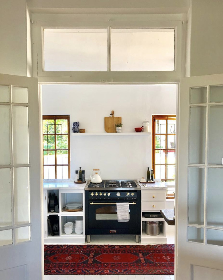 Painted white kitchen floor tiles in Australia and Persian runner