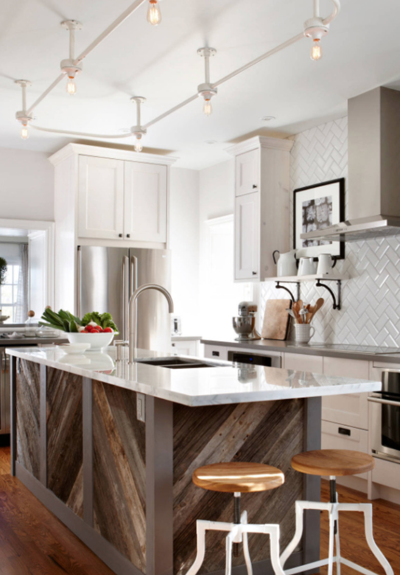 Gray kitchen island with reclaimed wood base and white counter.