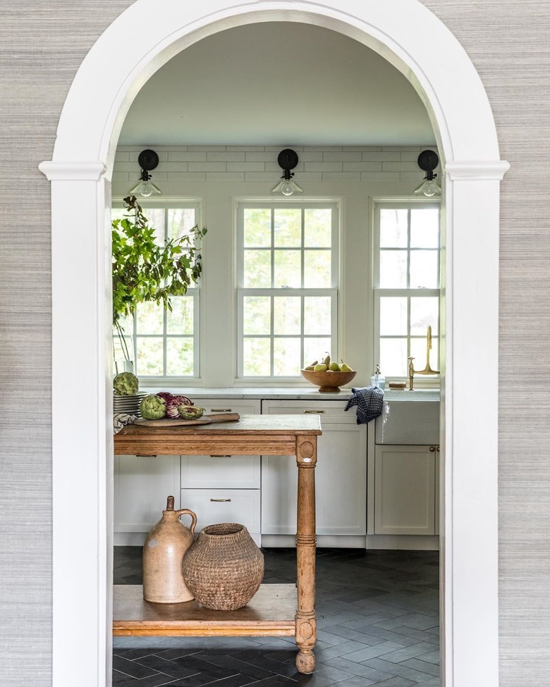 white kitchen dark floors with stone kitchen floors with white cabinets and wood island