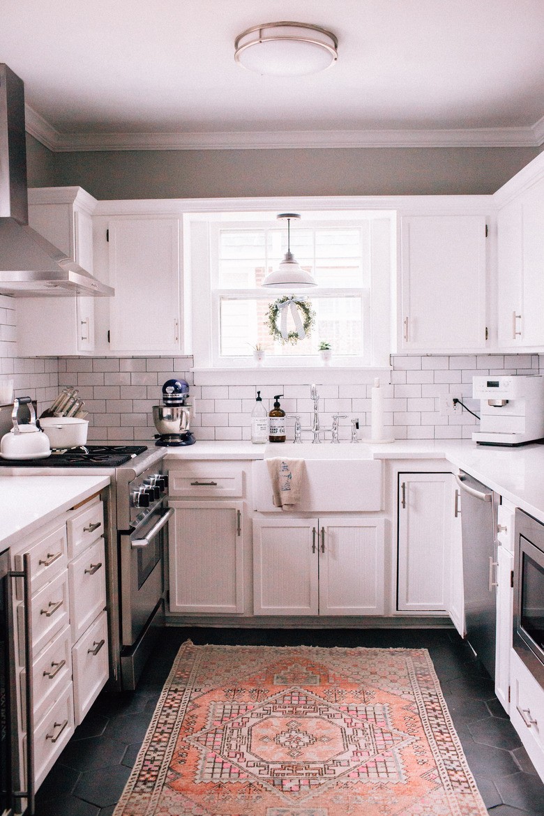 white kitchen dark floors with hexagon floors and kitchen rug