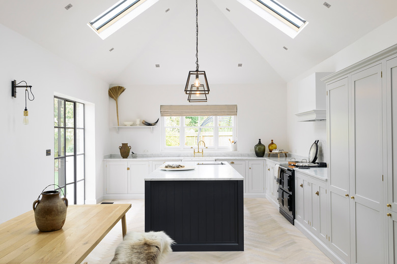 white kitchen with dark blue kitchen island