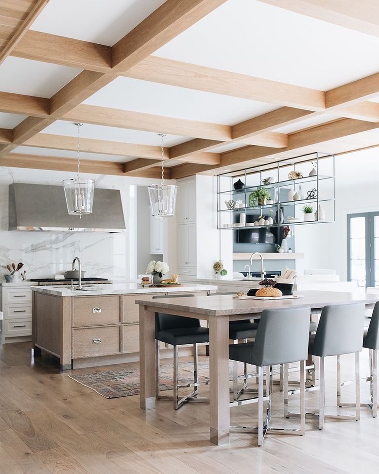 modern white kitchen with grey wood island and wood ceiling detail