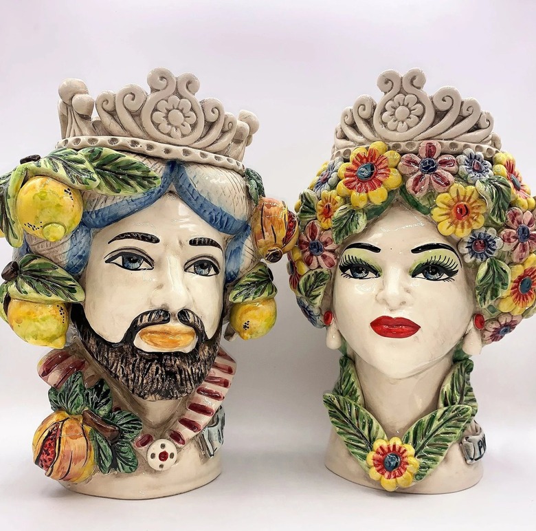 Two multicolored ceramic head figurines