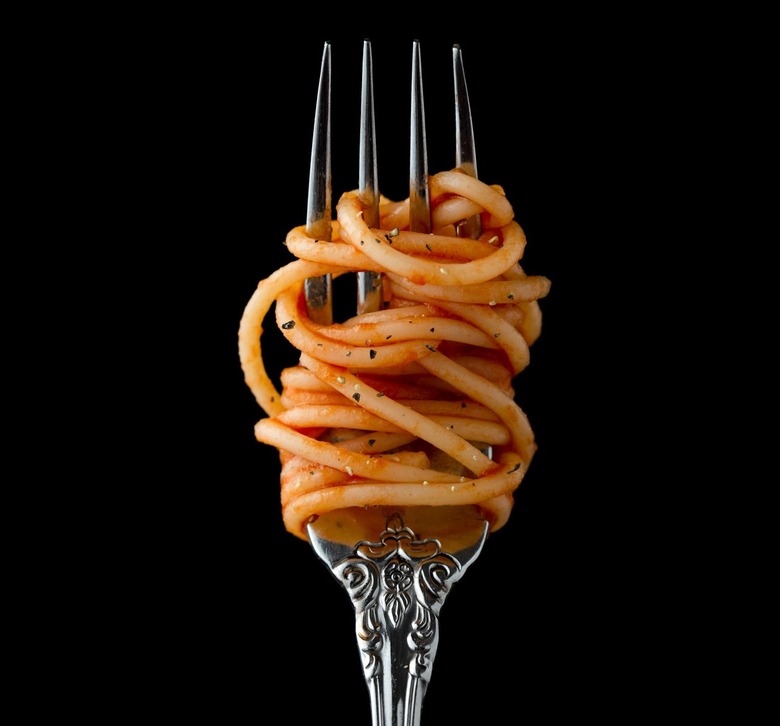 spaghetti with sauce twirled on silver spoon