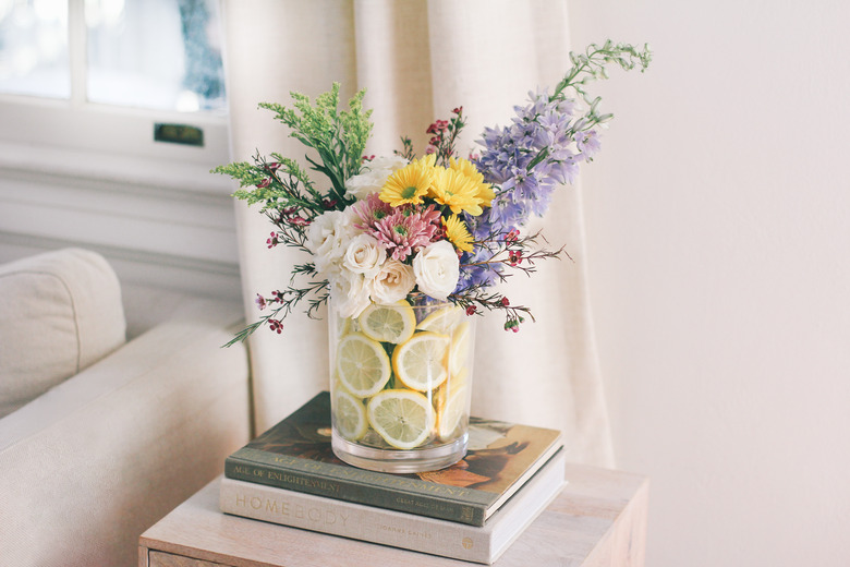 Lemons in a vase with flowers