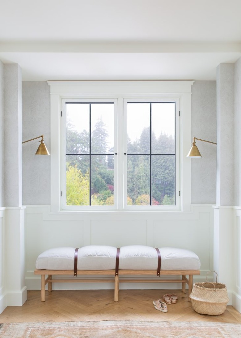 white hallway with simple window bench under a window