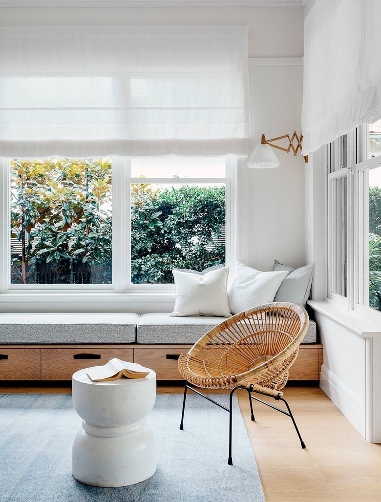 white sunroom with minimalist window bench with built-in drawers