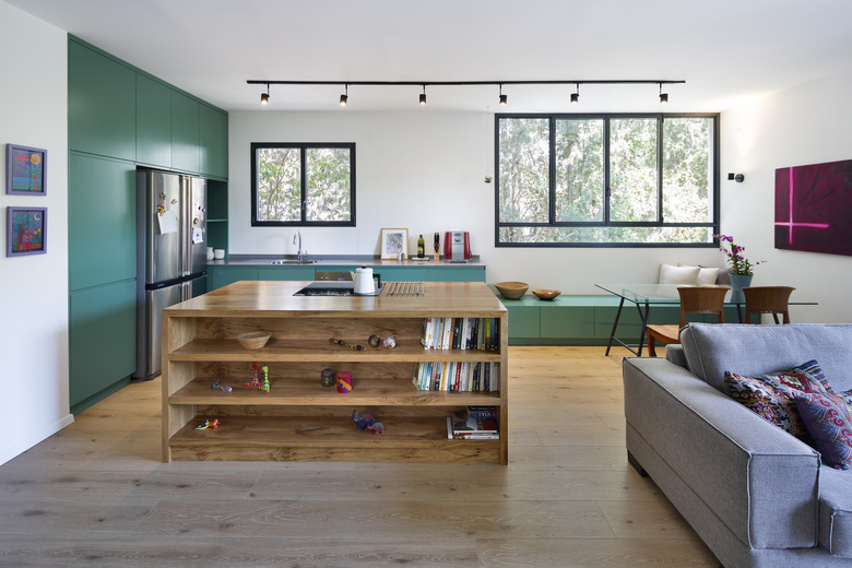 white modern kitchen with green cabinetry and matching window bench