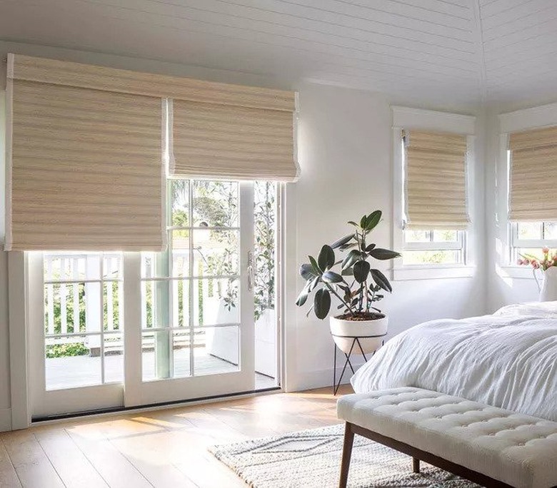 window treatments for sliding glass doors in white bedroom with plant