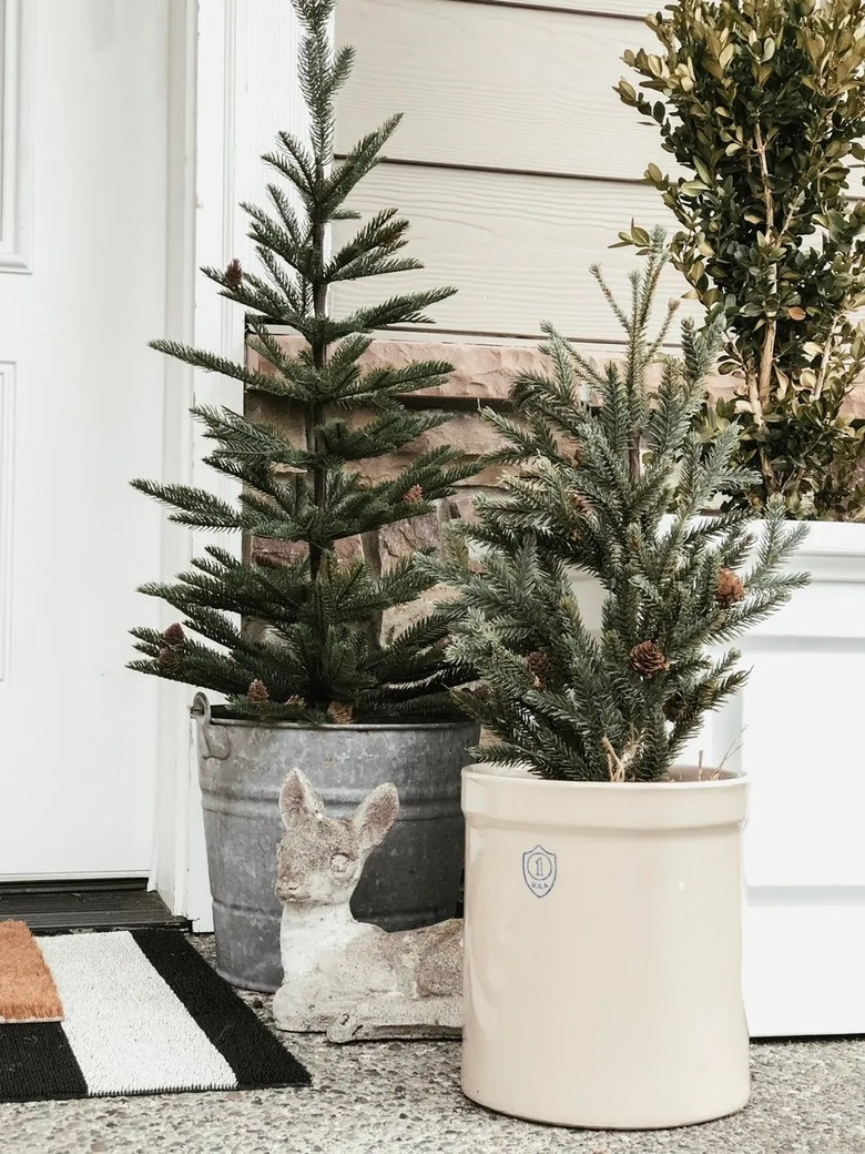 winter front porch with evergreens and deer