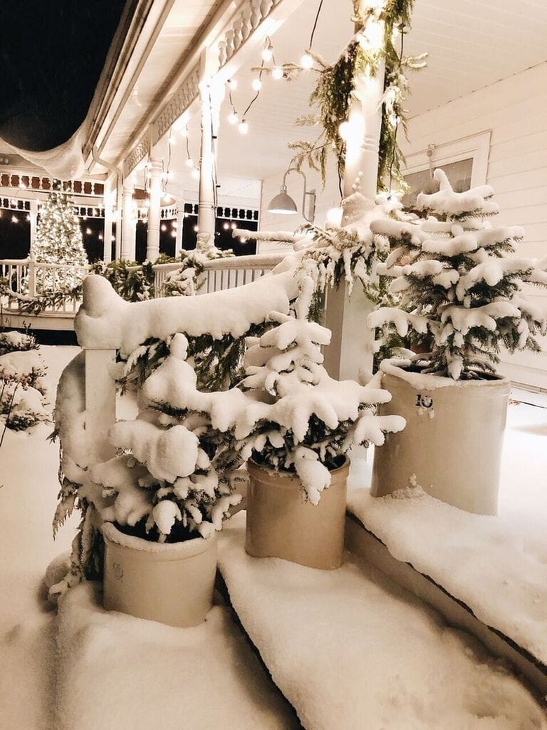 winter front porch with vintage crocks