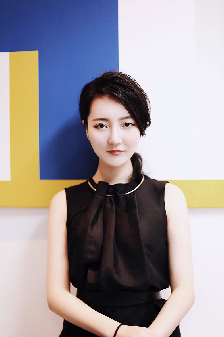 designer and architect li xiang in front of colorblocked wall