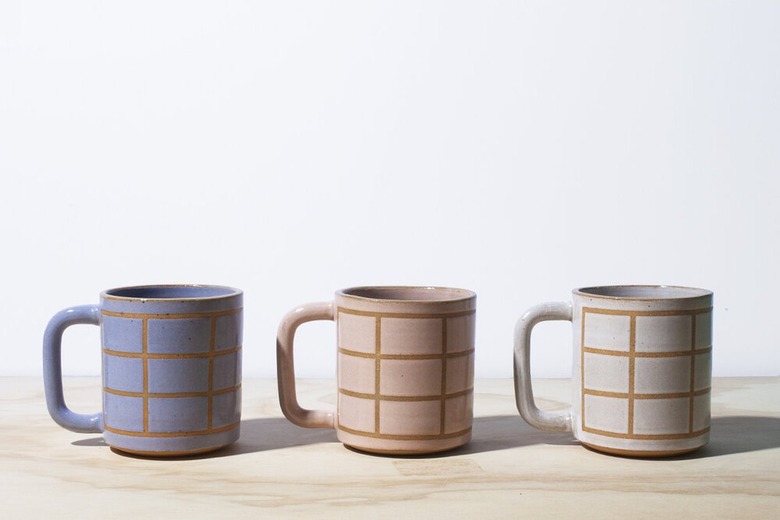 three mugs with grid pattern in various colors