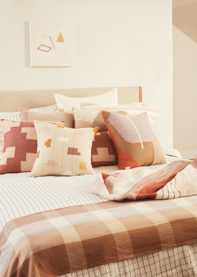 pink and neutral textiles on bed