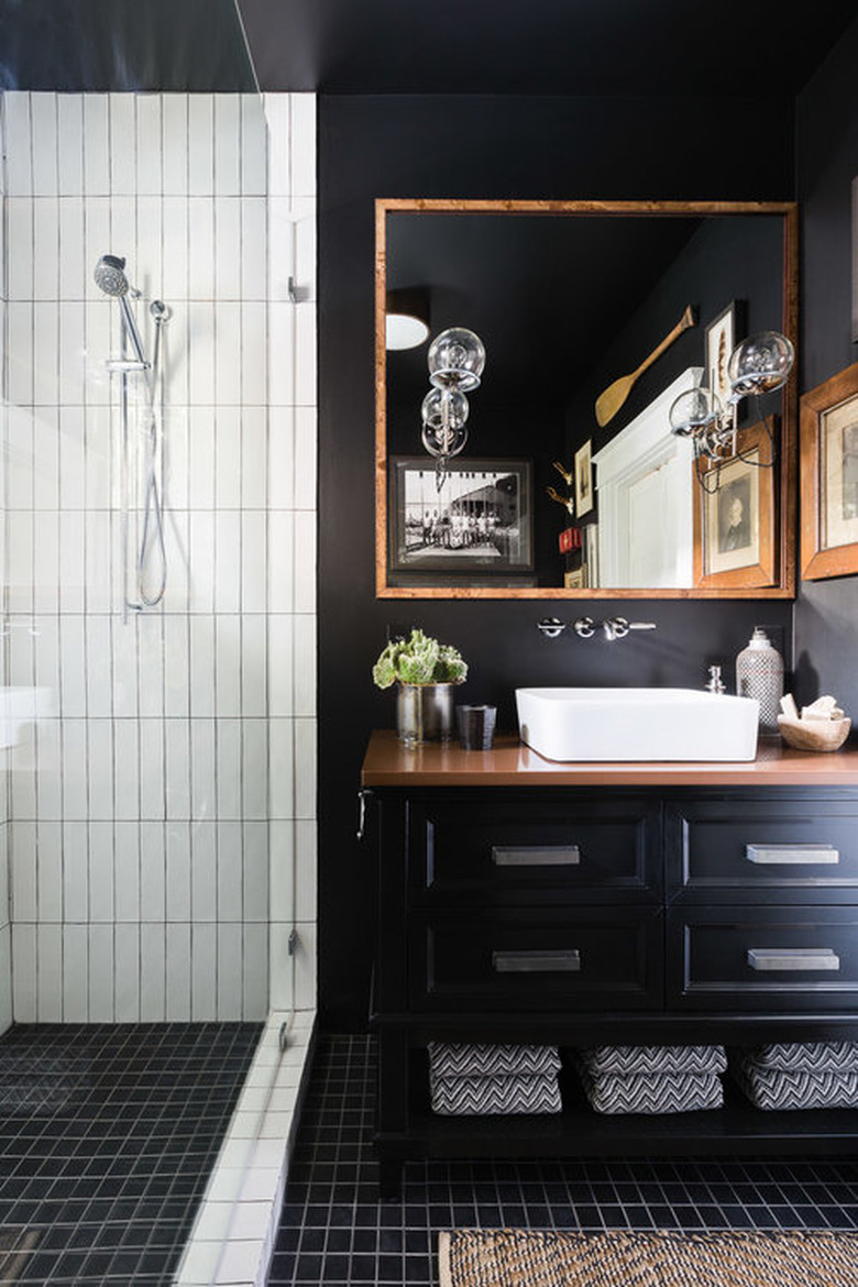 black bathroom with wood countertop