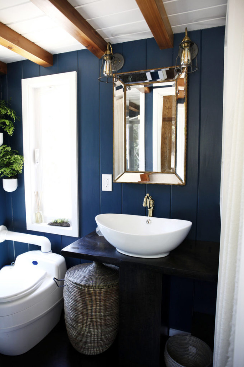 blue bathroom with wood countertop and bowl sink