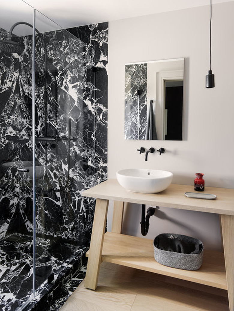 modern black and white bathroom with wood countertop and vanity