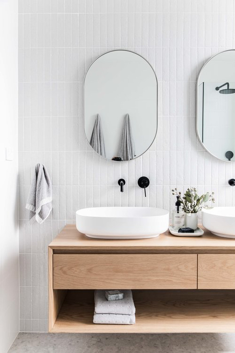 Scandinavian bathroom with floating wood vanity cabinet