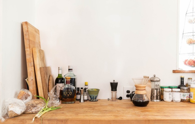 food, spices, and cutting boards on a wooden countertop