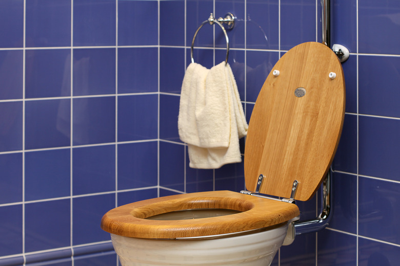 White toilet on blue tiles wall