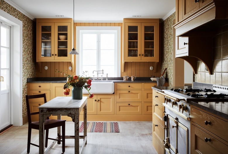 yellow kitchen with complementary floral wallpaper