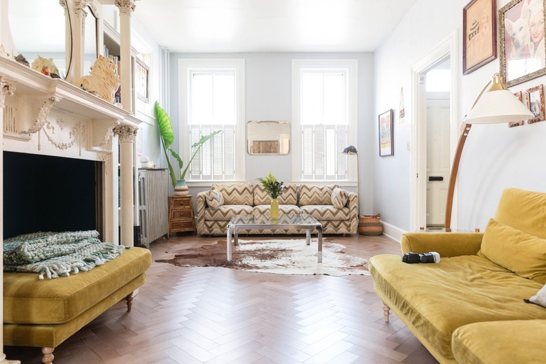 Yellow Room Ideas in Yellow couch, yellow cotton, zigzag pattern couch, chevron pattern wood floor, fireplace, white walls.