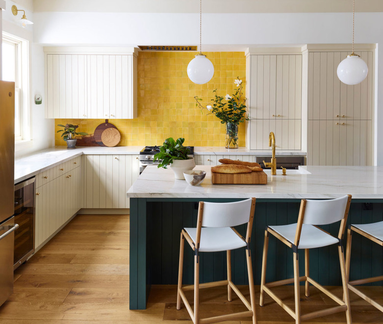 Yellow Room Ideas in Yellow tile backsplash, off white cupboards, white bar stools, kitchen island, white globe pendant lamps.