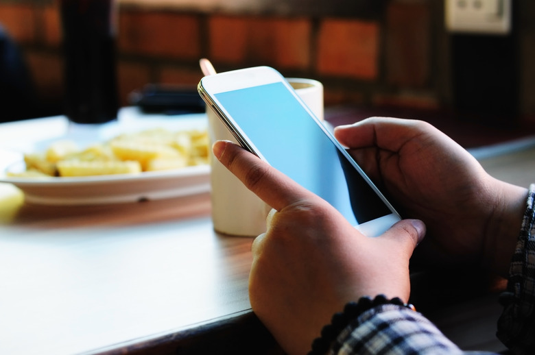 Close up of woman hands holding a smart phone