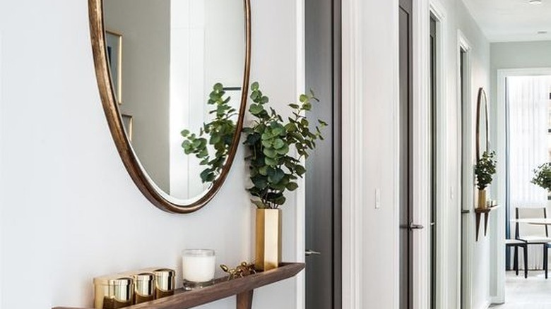 Circular mirror in hallway