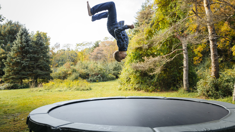 kid doing backflip on trampoline