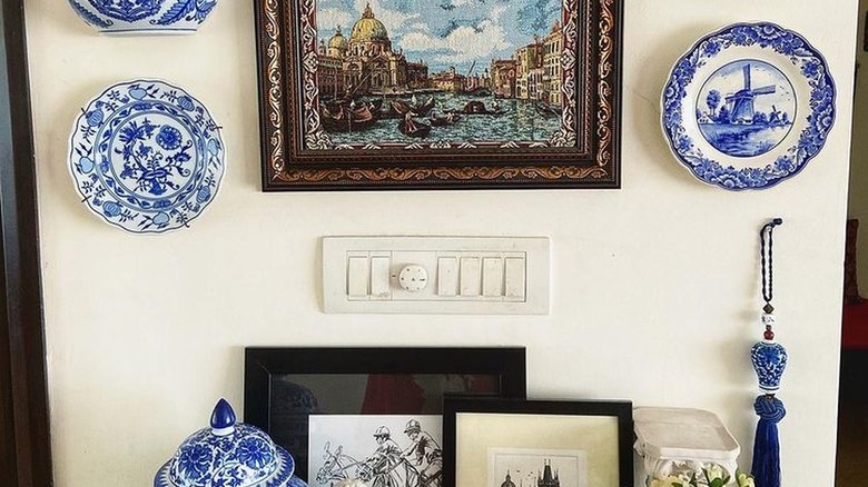 blue and white plates on wall next to decor table