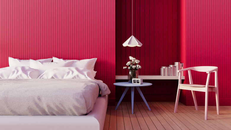 red bedroom walls with white bedding