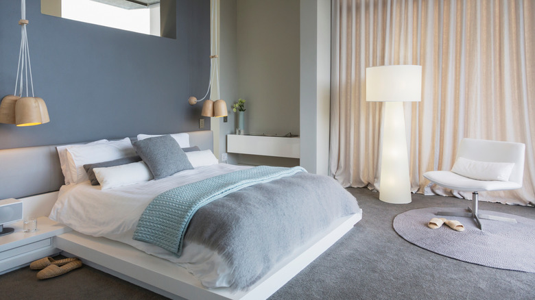 calm blue bedroom with white drapes