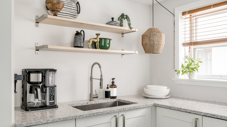 open shelving in kitchen with granite counters