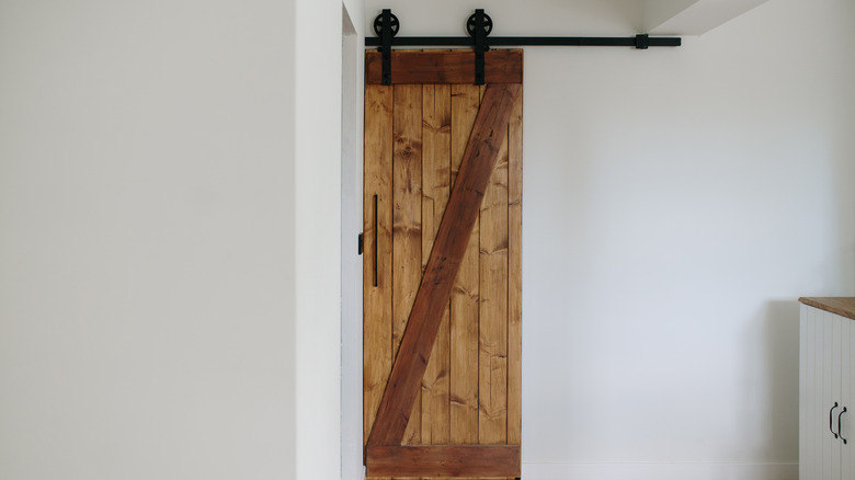 sliding wooden barn door in home