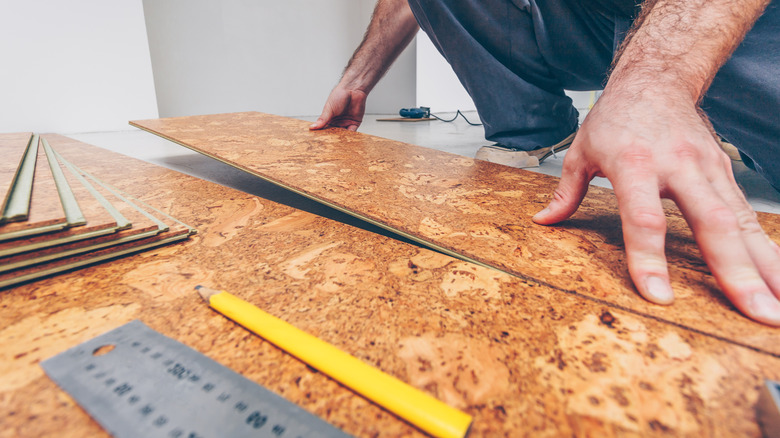 a mean is cutting cork flooring for installation