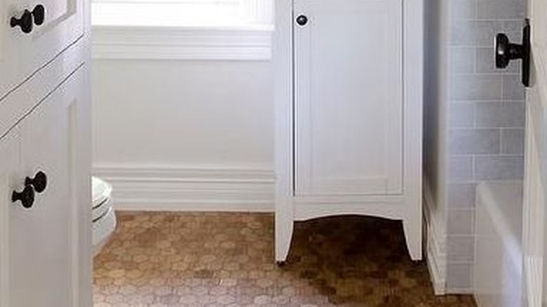 white bathroom with hexagonal cork flooring