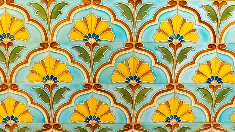 close up of Moroccan style tile with blue orange and yellow floral pattern