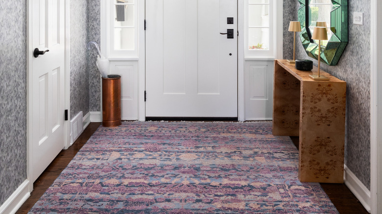 close up of entryway with large mirror in a unique frame