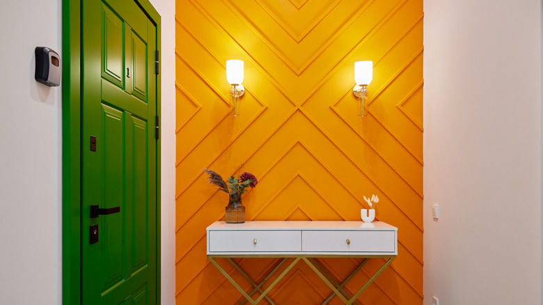 entryway with bold, orange accent wall