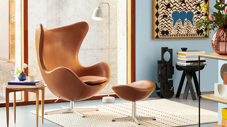 living room with replica of a brown leather Egg chair and ottoman