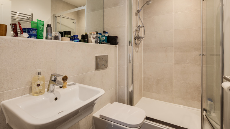 Small bathroom with miscellaneous toiletries left out