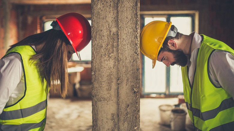 Frustrated man and woman dealing with building project