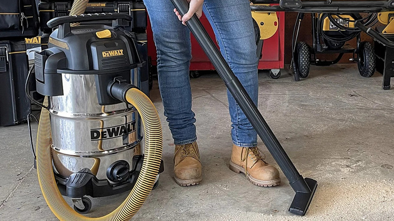 Cleaning workshop floor with Dewalt 8-gallon wet/dry vacuum