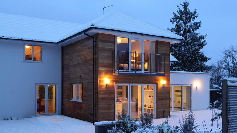 exterior of home on a snowy evening at dusk